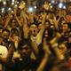 Protesters react as Joshua Wong (not pictured), leader of the student movement, speaks to the crowd outside the government headquarters building in Hong Kong October 1, 2014. Protesters react as Joshua Wong (not pictured), leader of the student movement, speaks to the crowd outside the government headquarters building in Hong Kong October 1, 2014.
